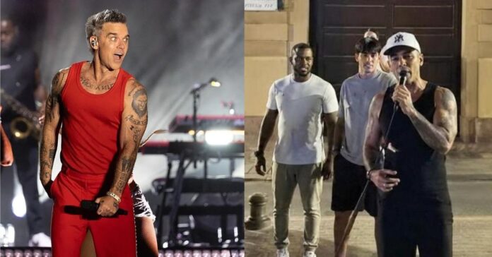 Robbie Williams sorprende en Sevilla: canta su éxito ‘Angels’ junto a un músico callejero en plena calle Santa María la Blanca